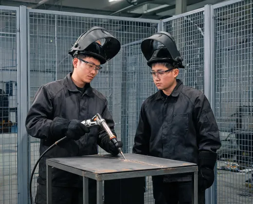 Welding instructor demonstrating torch position